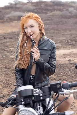 Lilly Mays Rides A Motorcycle In The Desert Wearing A Leather Jacket And Miniskirt